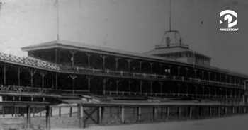 Vintage black and white photo of Gravesend Racetrack, from a similar perspective as the photo above, however it is now empty of people.