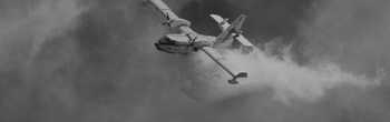 cover image of a firefighting plane dropping water over a fire