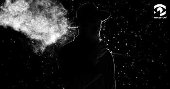 silhouette of a shadowy, hatted figure against a black background