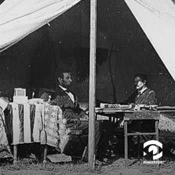 Lincoln sits inside a tent with General George B. “Little Mac” McClellan, Commander of the Army of the Potomac.