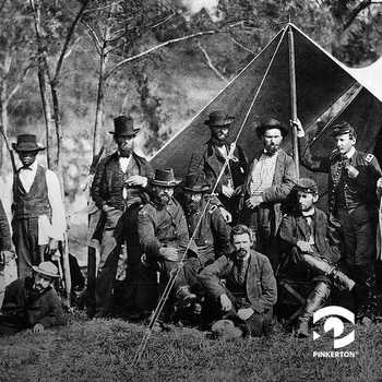 a photo of a group of men gathered outside a Civil War military tent
