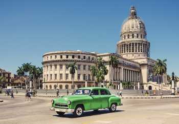 color photo from Havana, Cuba with a vintage green car in the foreground